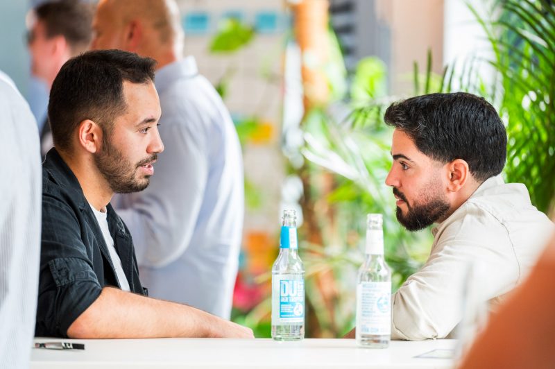 Tuna and Berk having a conversation about strategy at the Tech Sales Night in Düsseldorf